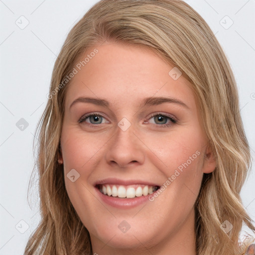 Joyful white young-adult female with long  brown hair and blue eyes