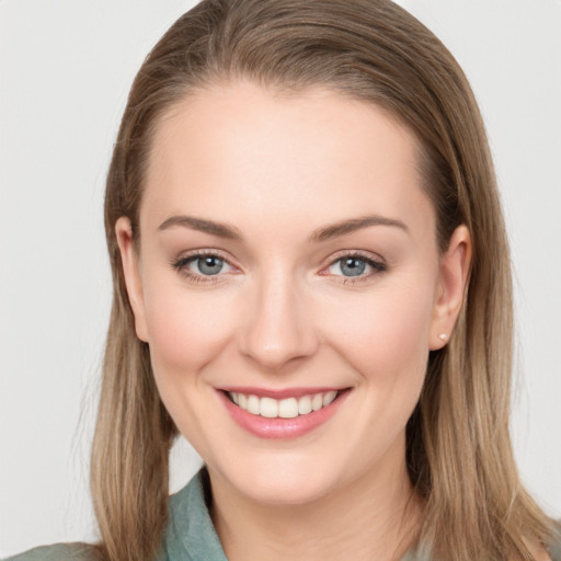 Joyful white young-adult female with long  brown hair and grey eyes