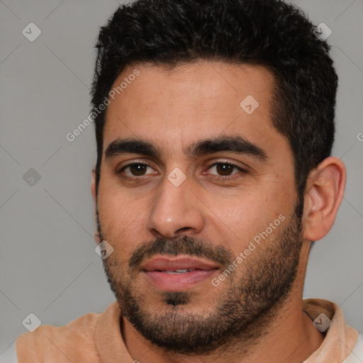 Joyful white young-adult male with short  black hair and brown eyes