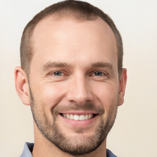 Joyful white adult male with short  brown hair and grey eyes