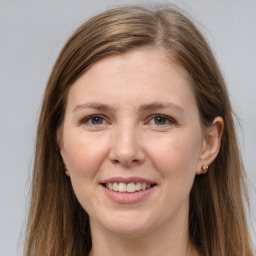 Joyful white young-adult female with long  brown hair and grey eyes