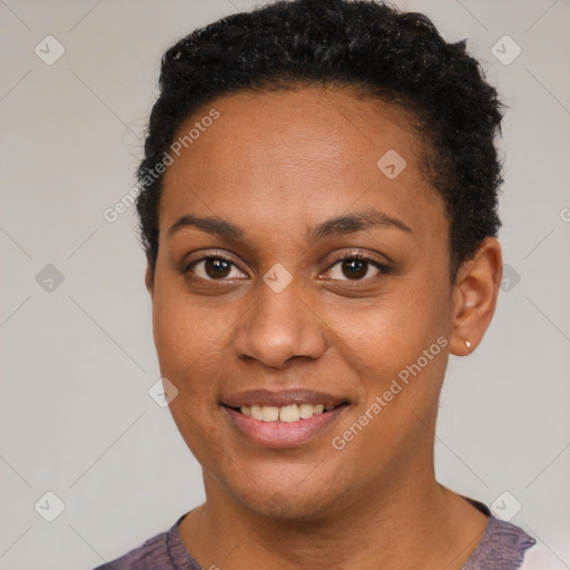 Joyful black young-adult female with short  black hair and brown eyes