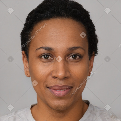 Joyful black adult female with short  black hair and brown eyes