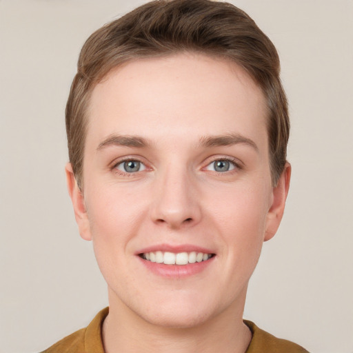 Joyful white young-adult female with short  brown hair and grey eyes