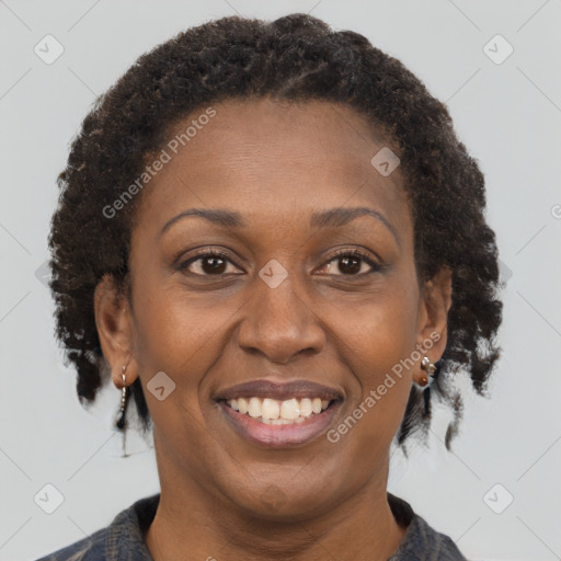 Joyful black adult female with short  brown hair and brown eyes