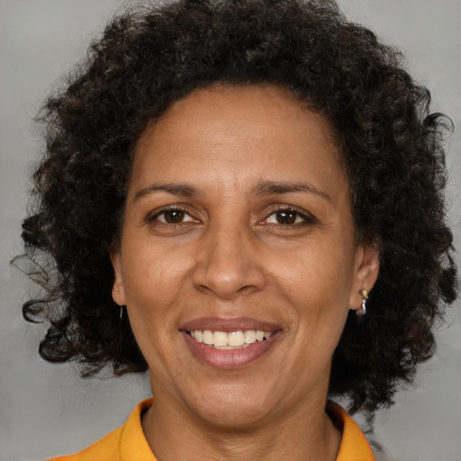 Joyful black adult female with short  brown hair and brown eyes