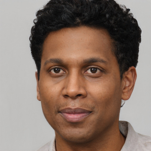 Joyful latino adult male with short  black hair and brown eyes