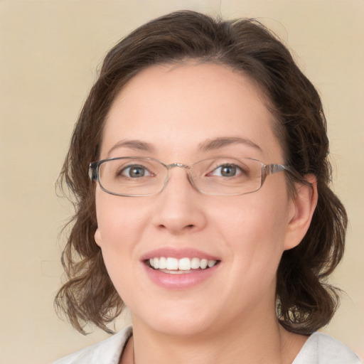 Joyful white young-adult female with medium  brown hair and green eyes