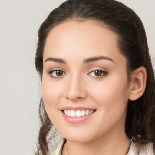 Joyful white young-adult female with long  brown hair and brown eyes