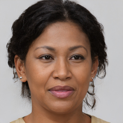 Joyful black adult female with medium  brown hair and brown eyes