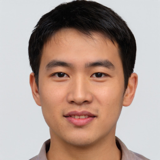 Joyful asian young-adult male with short  black hair and brown eyes