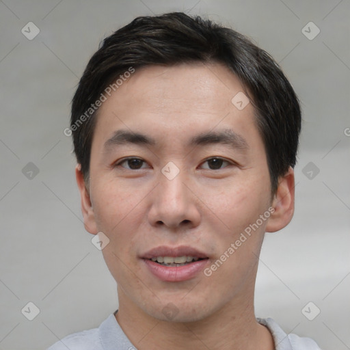 Joyful asian young-adult male with short  black hair and brown eyes