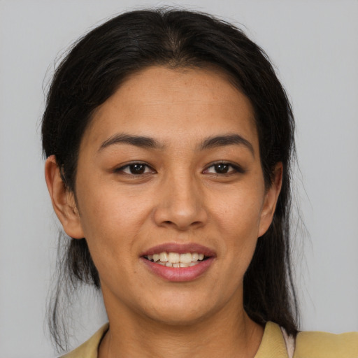 Joyful latino young-adult female with medium  brown hair and brown eyes