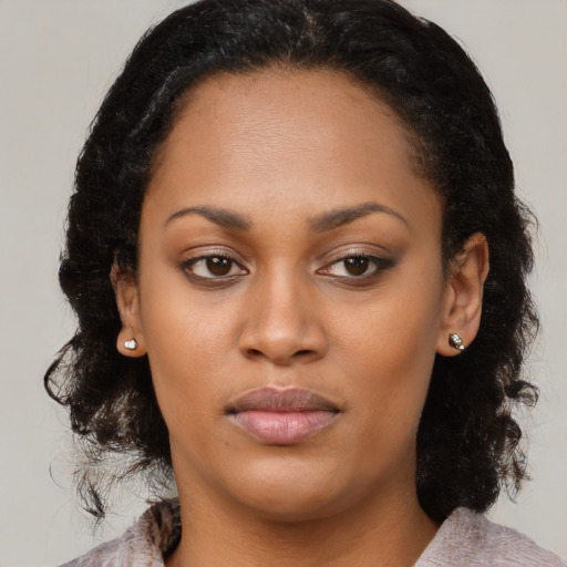 Joyful black young-adult female with medium  brown hair and brown eyes