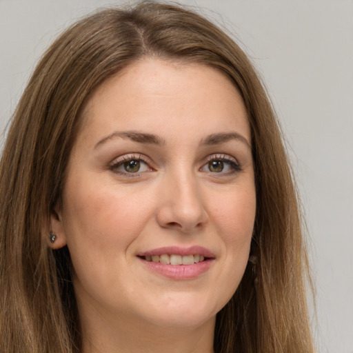 Joyful white young-adult female with long  brown hair and green eyes