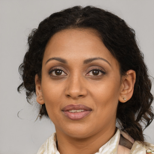Joyful black adult female with medium  brown hair and brown eyes