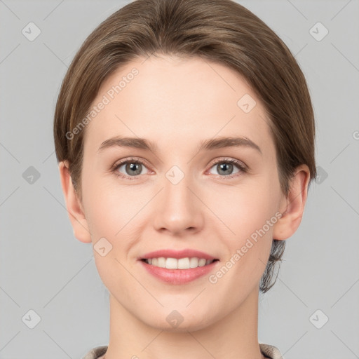 Joyful white young-adult female with short  brown hair and grey eyes