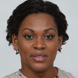 Joyful black adult female with short  brown hair and brown eyes