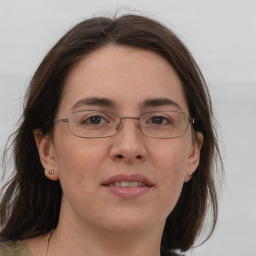 Joyful white adult female with medium  brown hair and grey eyes