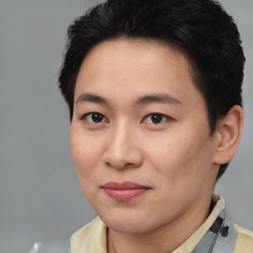 Joyful asian young-adult female with short  brown hair and brown eyes