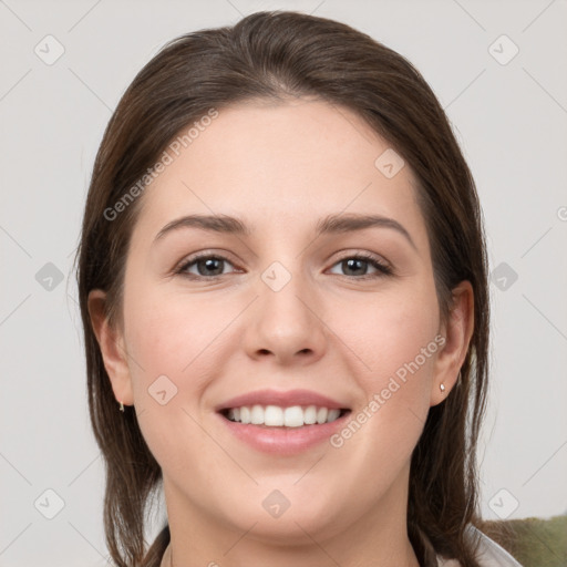 Joyful white young-adult female with medium  brown hair and grey eyes