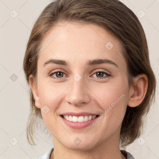 Joyful white young-adult female with medium  brown hair and green eyes