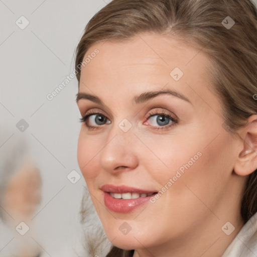 Joyful white young-adult female with medium  brown hair and blue eyes