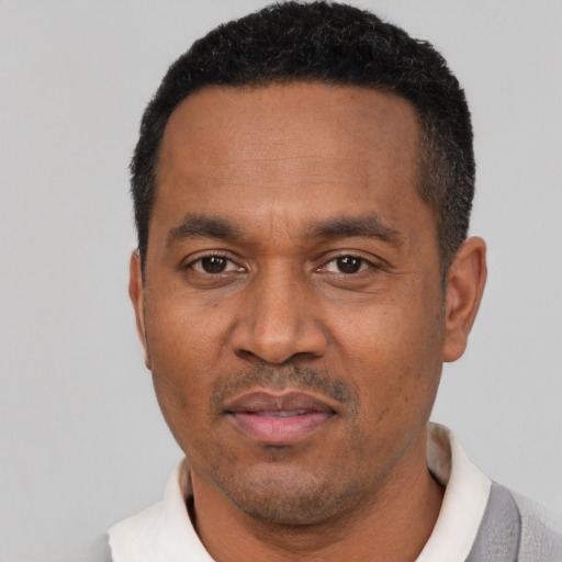 Neutral latino adult male with short  black hair and brown eyes