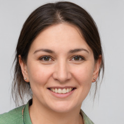 Joyful white young-adult female with medium  brown hair and brown eyes