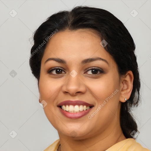 Joyful latino young-adult female with medium  brown hair and brown eyes