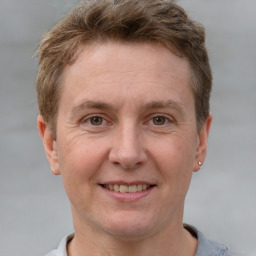 Joyful white adult male with short  brown hair and grey eyes