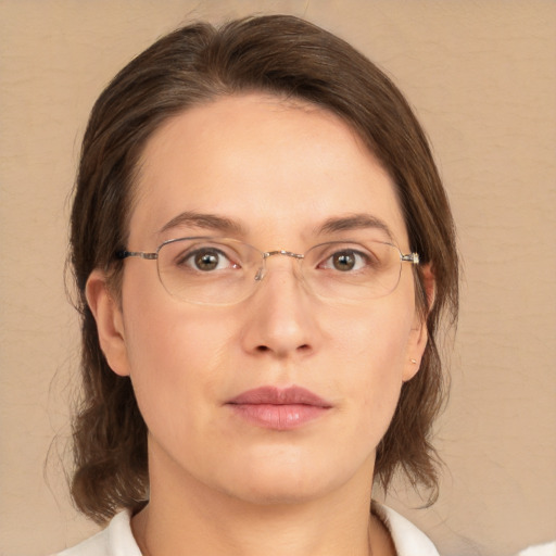 Joyful white adult female with medium  brown hair and green eyes