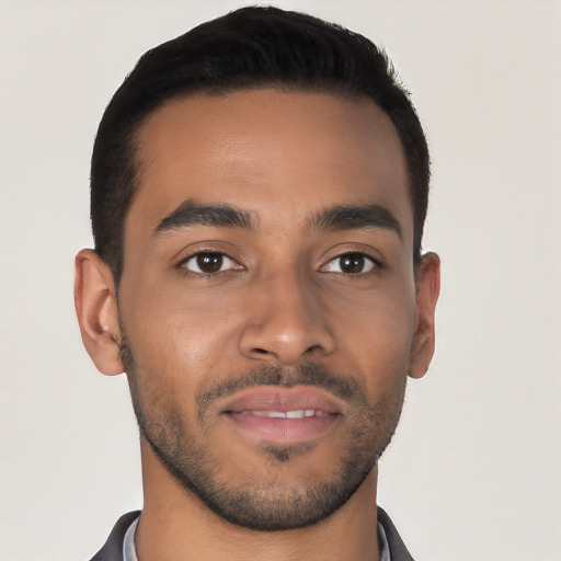 Joyful latino young-adult male with short  brown hair and brown eyes