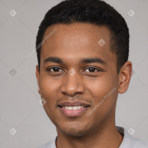 Joyful black young-adult male with short  brown hair and brown eyes