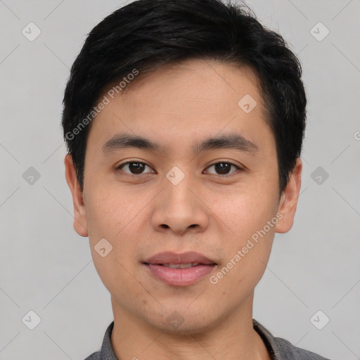 Joyful asian young-adult male with short  black hair and brown eyes