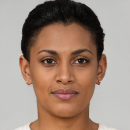 Joyful latino young-adult female with short  brown hair and brown eyes