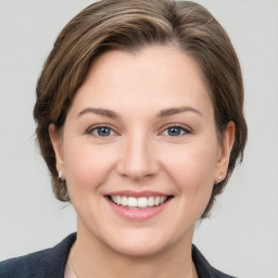 Joyful white young-adult female with medium  brown hair and grey eyes