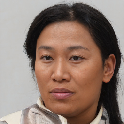 Joyful asian adult female with medium  brown hair and brown eyes