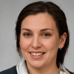 Joyful white adult female with medium  brown hair and brown eyes