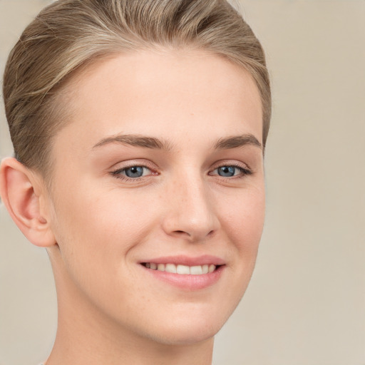 Joyful white young-adult female with short  brown hair and grey eyes