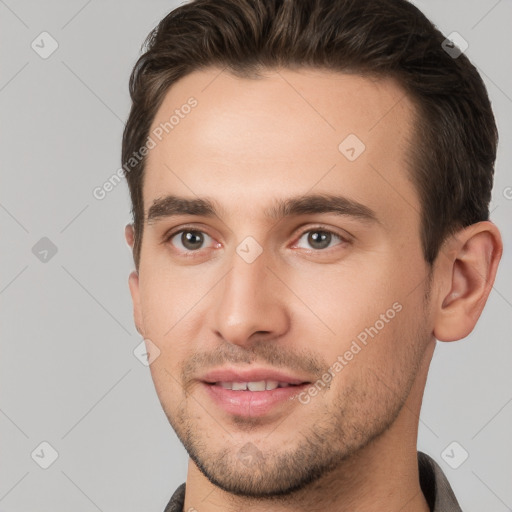 Joyful white young-adult male with short  brown hair and brown eyes