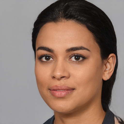 Joyful latino young-adult female with medium  black hair and brown eyes