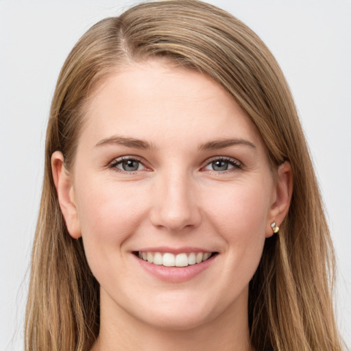 Joyful white young-adult female with long  brown hair and grey eyes