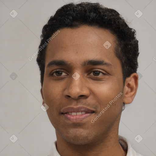 Joyful black young-adult male with short  brown hair and brown eyes