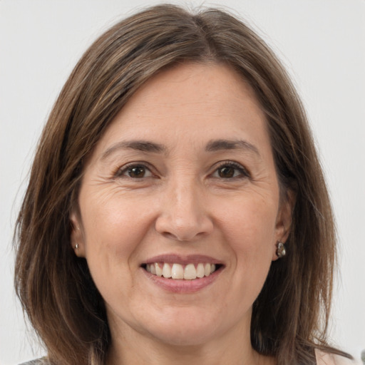 Joyful white adult female with medium  brown hair and grey eyes