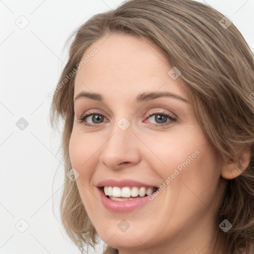 Joyful white young-adult female with long  brown hair and green eyes