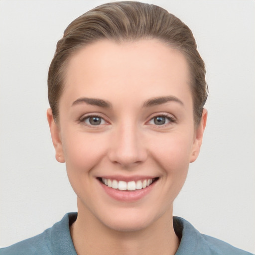 Joyful white young-adult female with short  brown hair and grey eyes