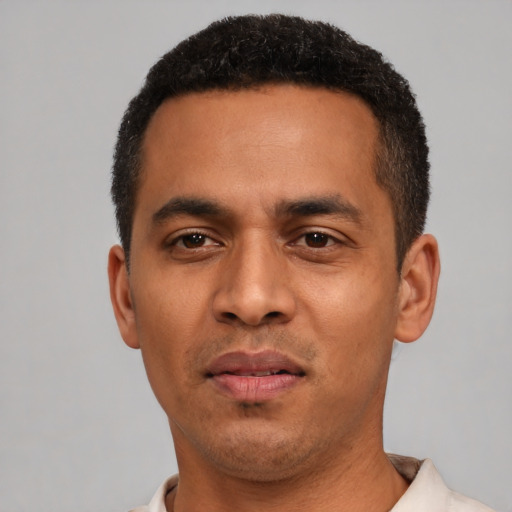 Neutral latino young-adult male with short  black hair and brown eyes