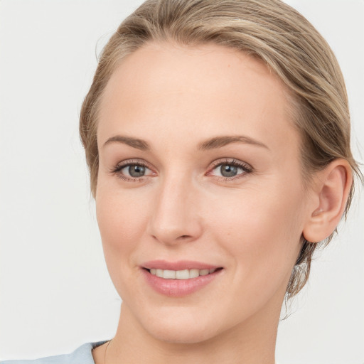 Joyful white young-adult female with medium  brown hair and blue eyes