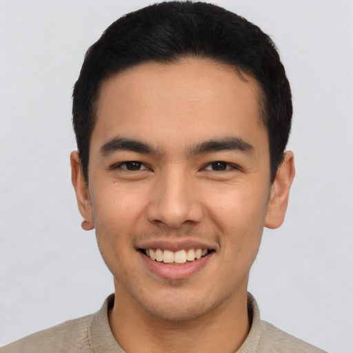 Joyful asian young-adult male with short  brown hair and brown eyes